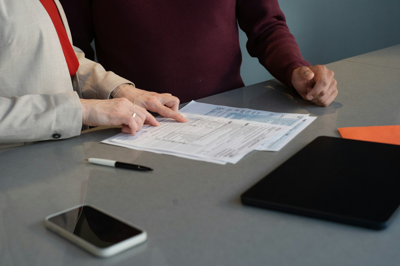 Two people reviewing documents at a table