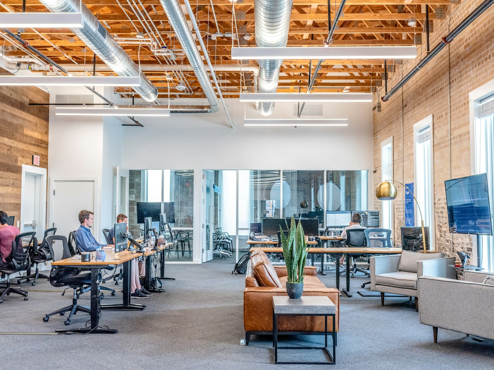 Payments company team at work across multiple monitors